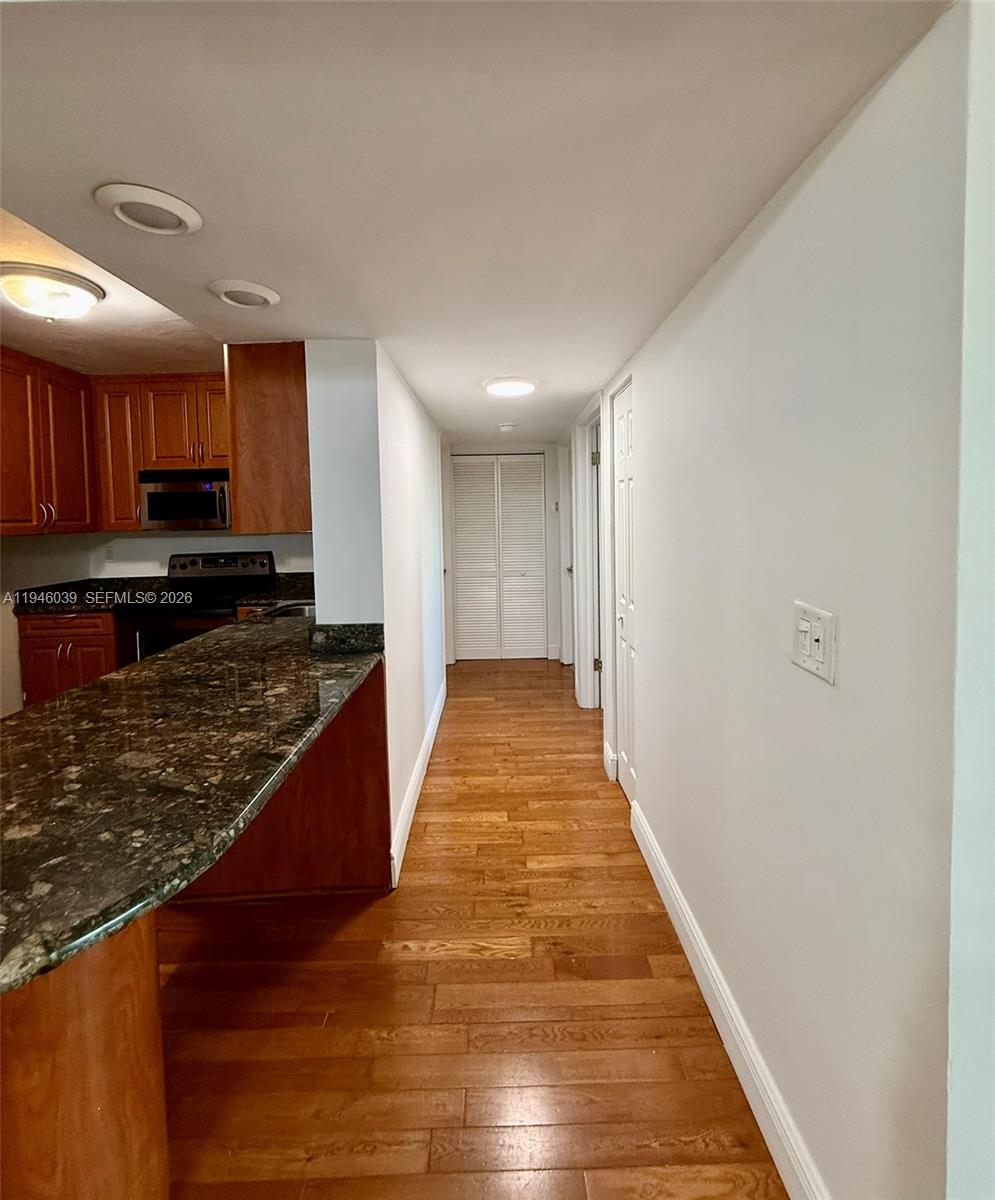 1605 Bay Road, Unit 407 Miami Beach, FL 33139 - Photo 6 of 31 a view of kitchen with wooden floor