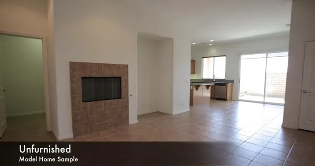 a view of a hallway with wooden floor and a kitchen