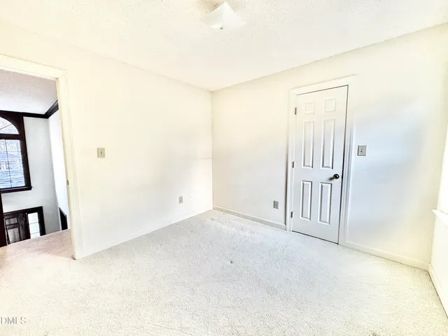 a view of a room with wooden floor and cabinet