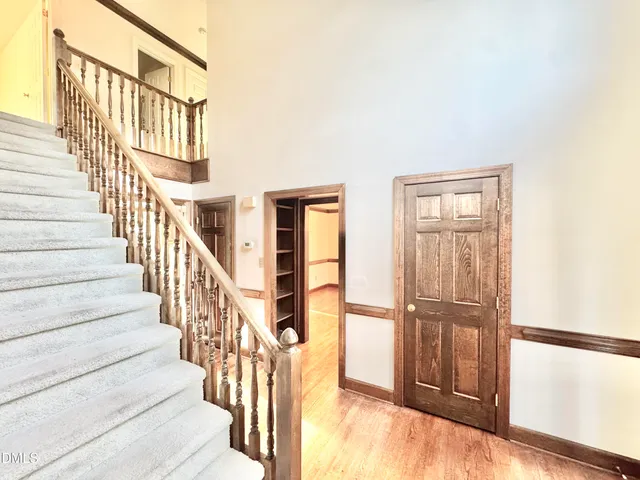 a large white bathroom with a granite countertop sink and a large mirror
