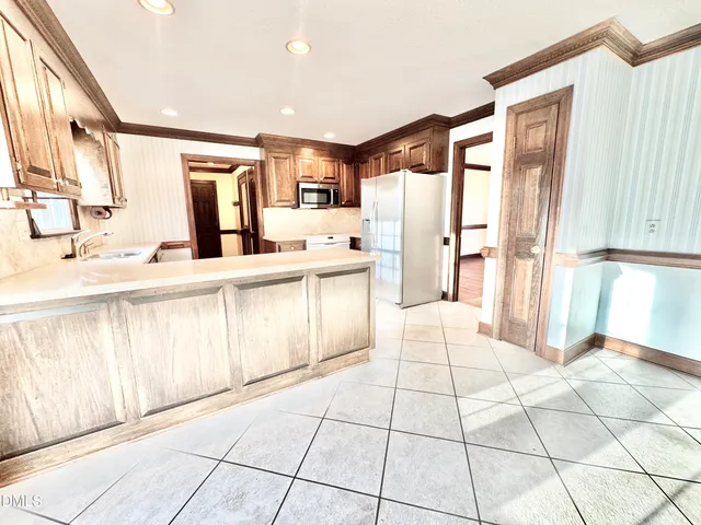 a living room with a bed furniture and a large window