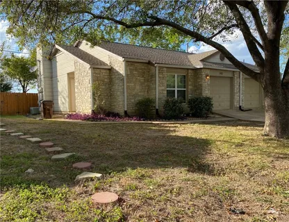 a view of a kitchen with a sink and a refrigerator