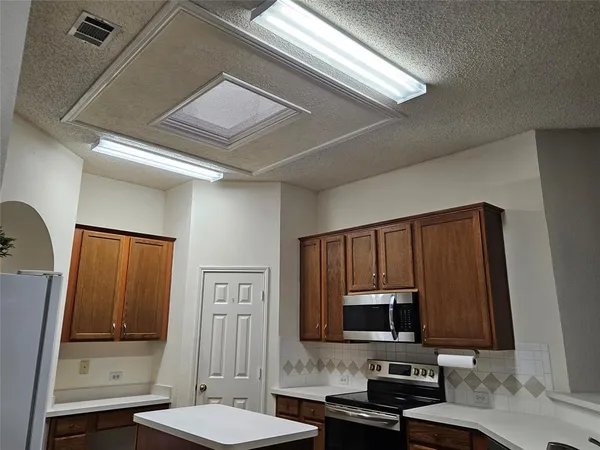 a kitchen with stainless steel appliances a sink and a refrigerator