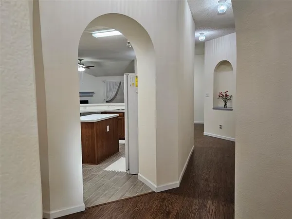 a view of a hallway with wooden floor