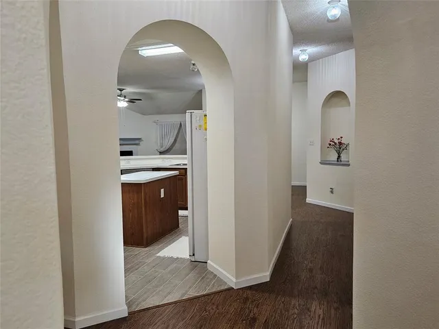 a view of a hallway with wooden floor