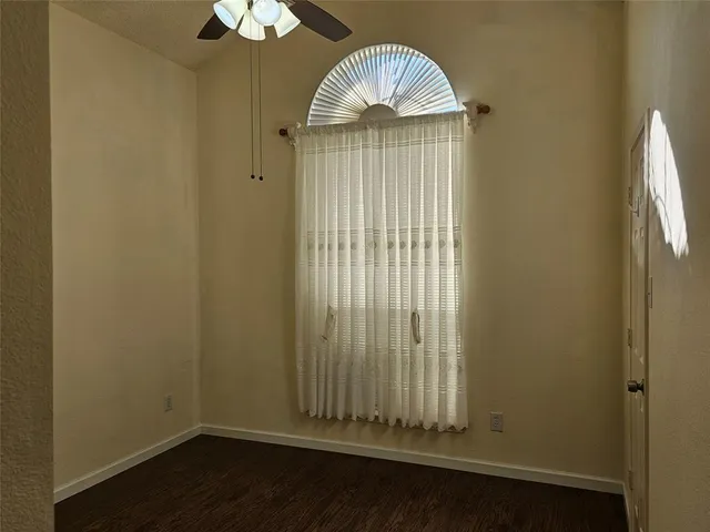a view of a small space with wooden floor and a window
