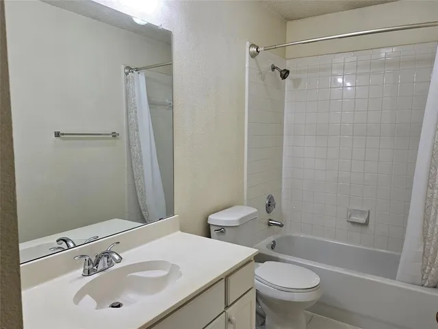 a kitchen with stainless steel appliances granite countertop a stove a sink dishwasher and a microwave oven with wooden cabinets