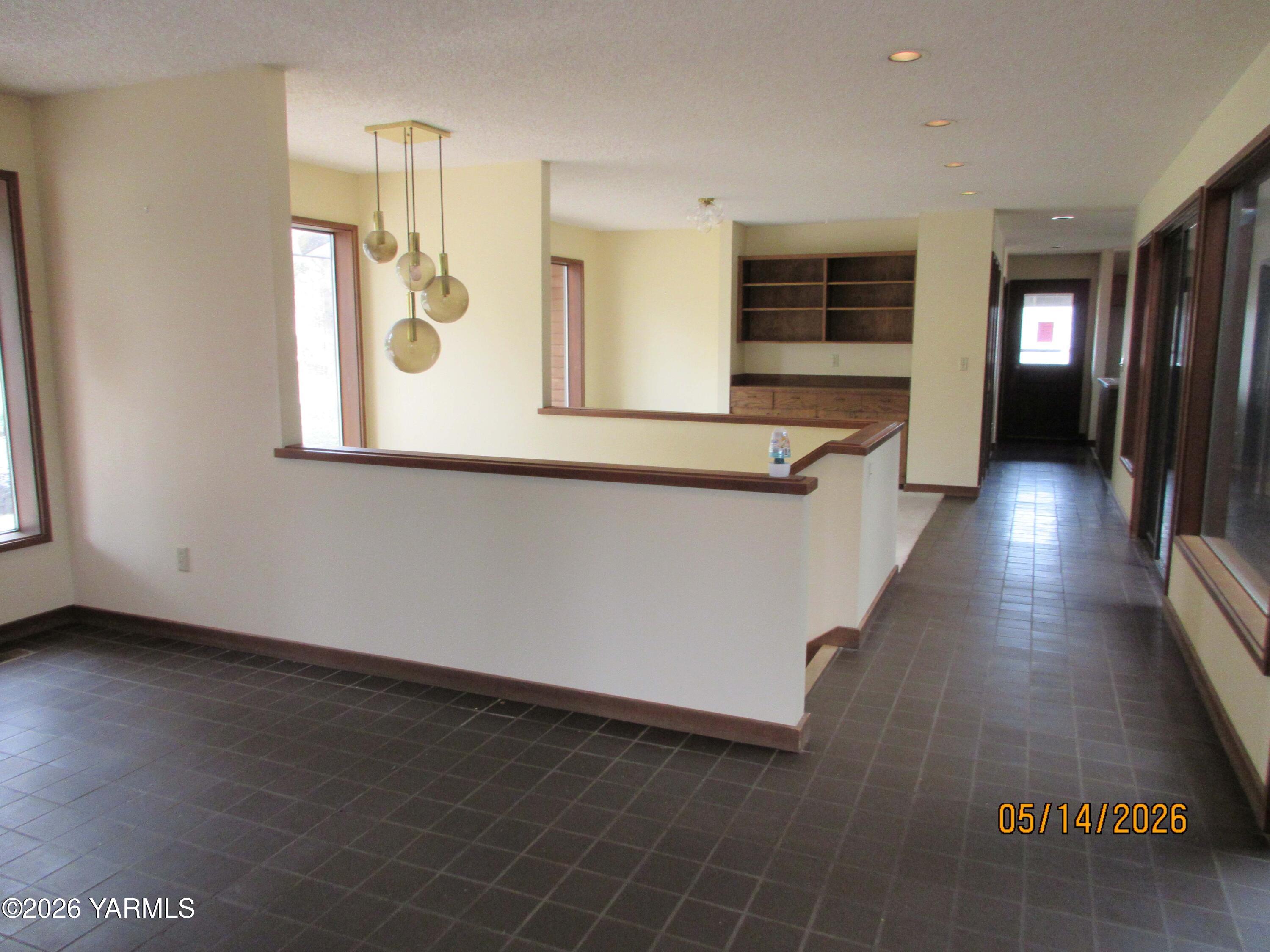 1303 Nightingale Road Wapato, WA 98951 - Photo 5 of 26 a view of a kitchen with wooden floor and a window