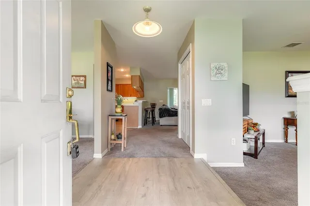 a dining room with furniture a chandelier and window