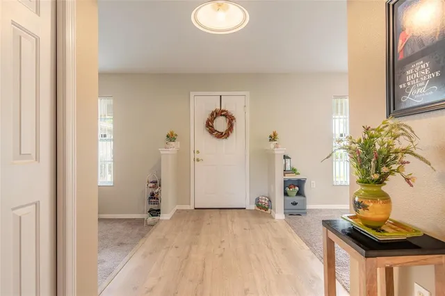 a dining room with furniture a chandelier and window