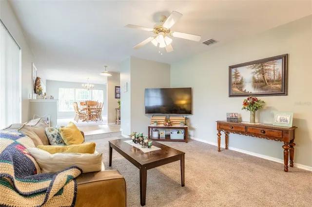 a view of a livingroom with furniture and a ceiling fan