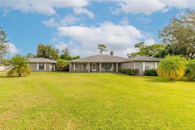 a front view of a house with a big yard