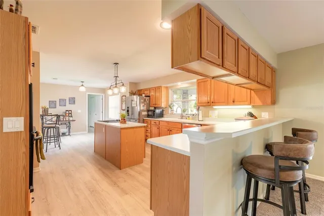 a spacious bedroom with a bed and a chandelier