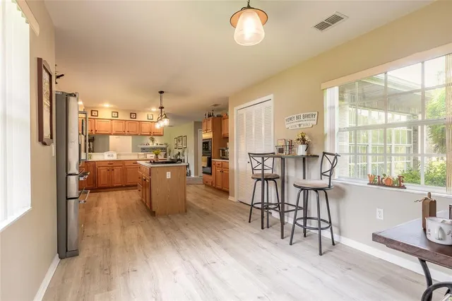 a spacious bedroom with a bed and a chandelier