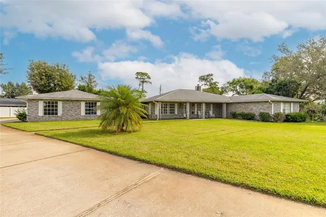 a front view of house with yard swimming pool and seating