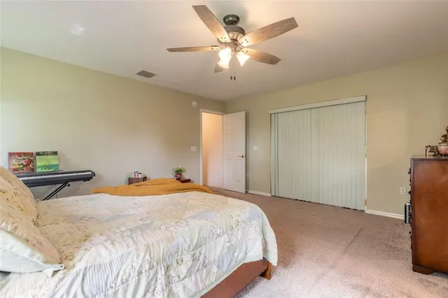 an aerial view of residential houses with outdoor space and trees