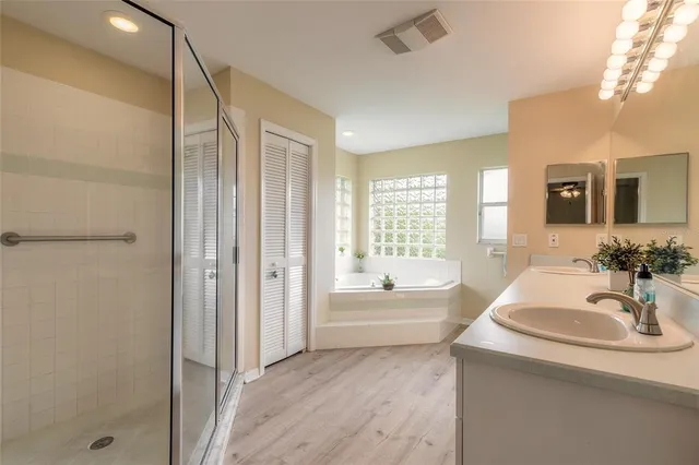 an aerial view of residential houses with outdoor space and trees
