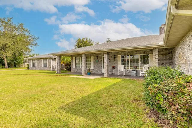 a view of a house with swimming pool and porch