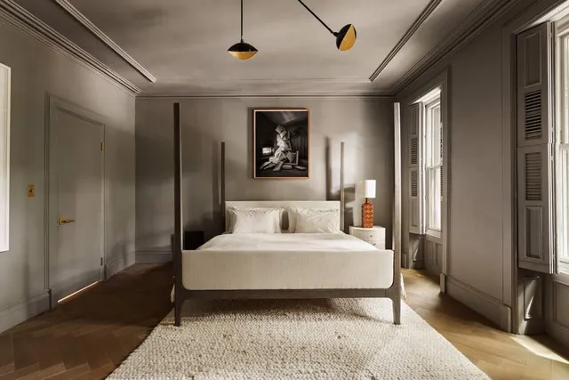 a bedroom with a large bed and a window