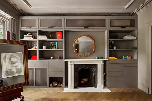 a living room with a fireplace and a wooden floor