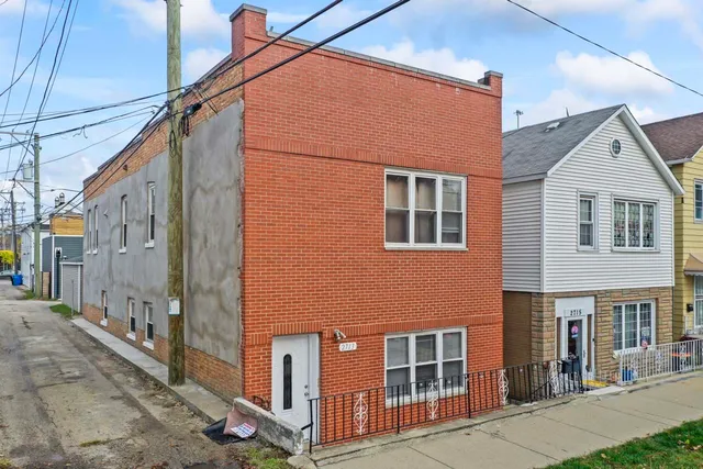 a front view of a house with many windows