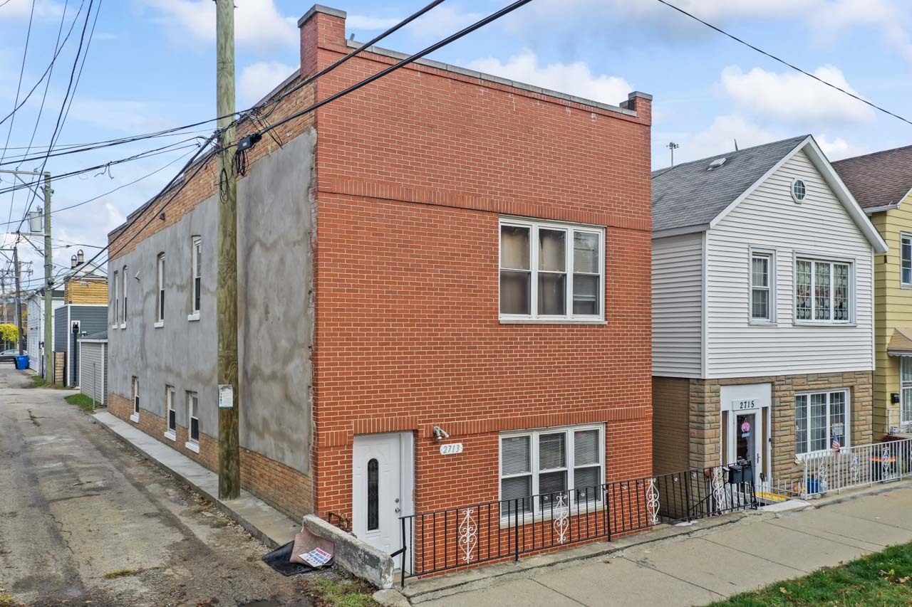 a front view of a house with many windows