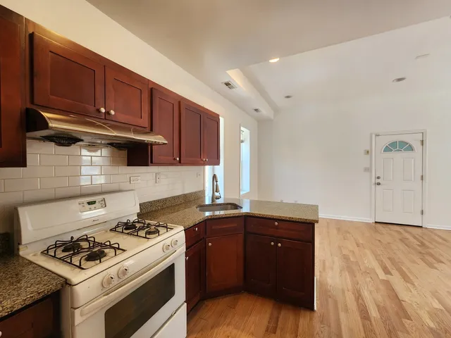 a view of a kitchen with a sink and a window