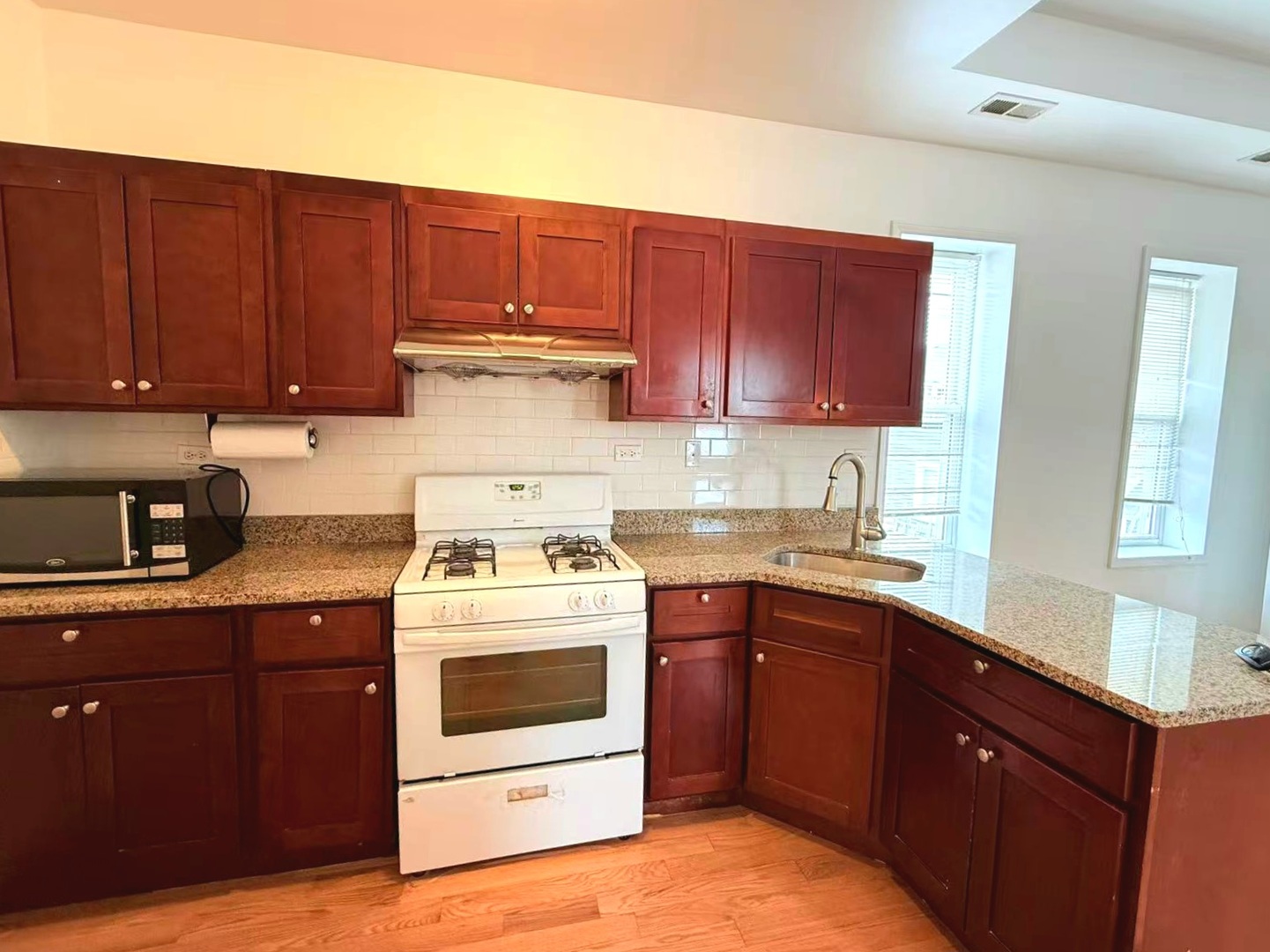 2713 South Crowell Street Chicago, IL 60608 - Photo 26 of 50 a kitchen with a stove top oven sink and cabinets
