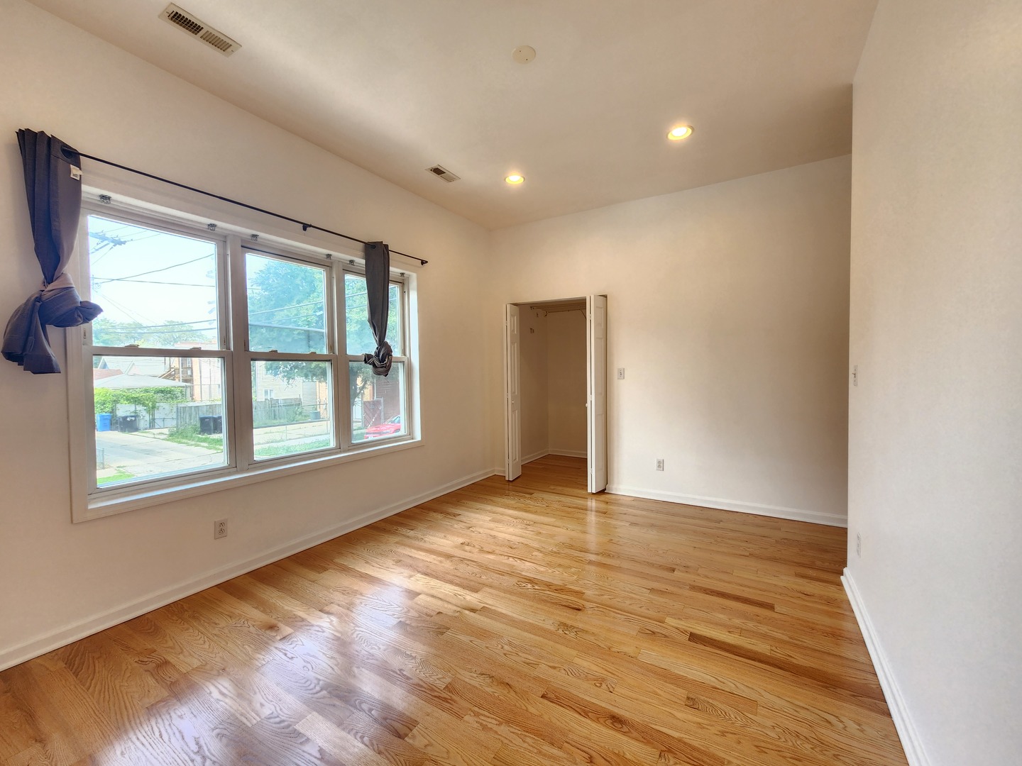 2713 South Crowell Street Chicago, IL 60608 - Photo 32 of 50 an empty room with wooden floor and windows