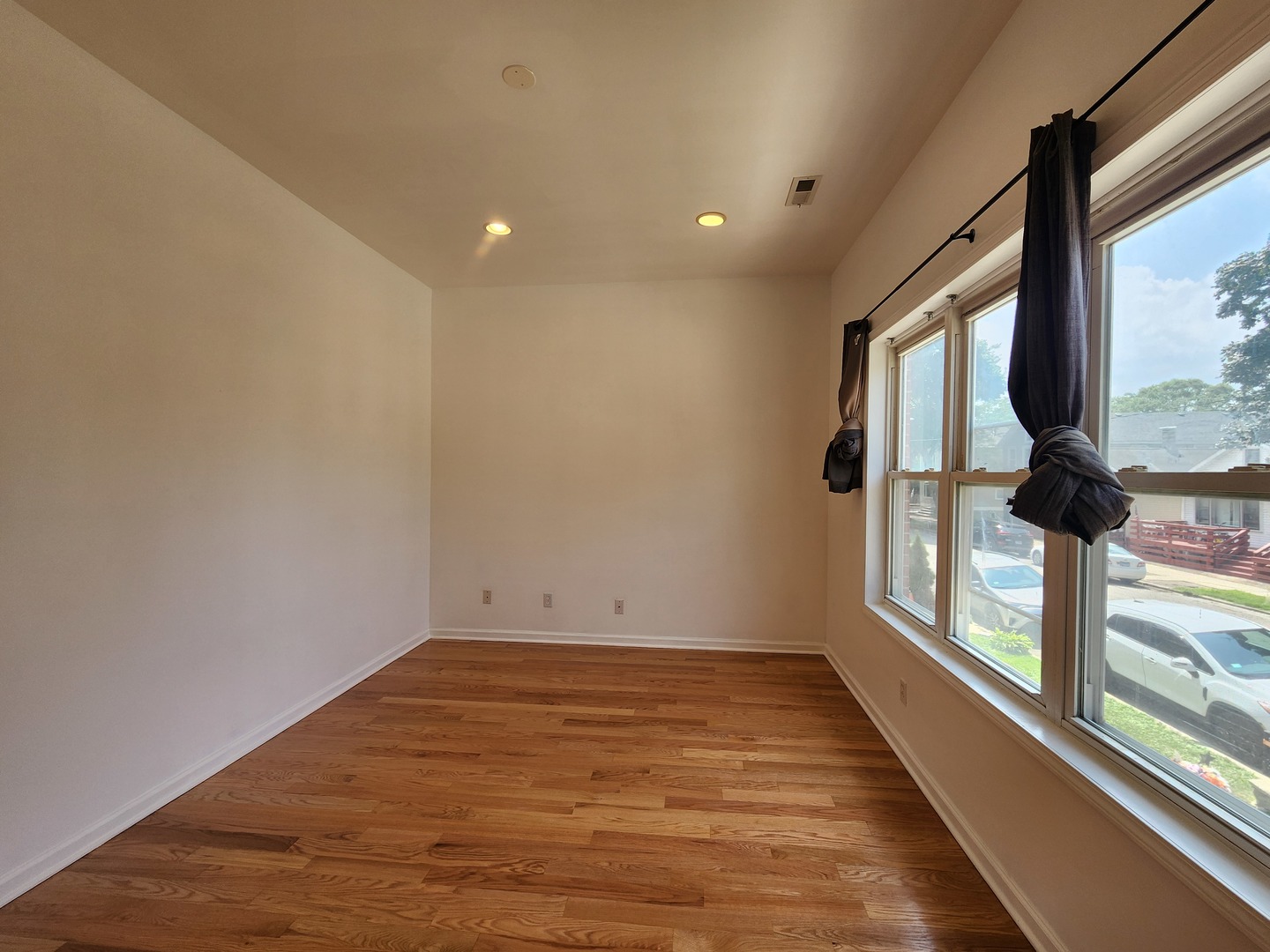 2713 South Crowell Street Chicago, IL 60608 - Photo 34 of 50 a view of empty room with wooden floor and fan