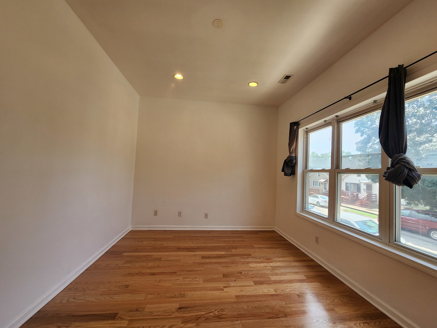 2713 South Crowell Street Chicago, IL 60608 - Photo 35 of 50 an empty room with wooden floor and windows