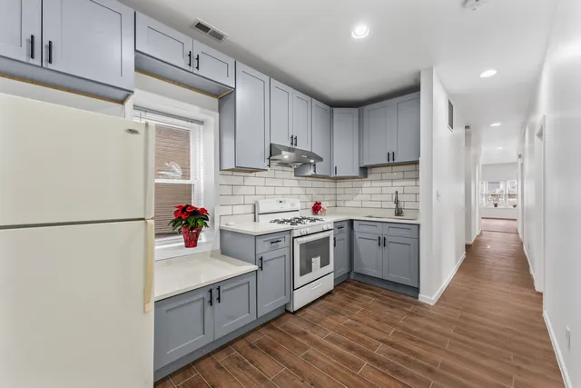 a kitchen with a refrigerator sink and cabinets