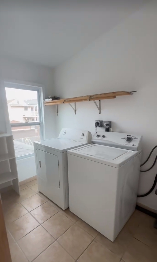 2713 South Crowell Street Chicago, IL 60608 - Photo 41 of 50 a utility room with cabinets washer and dryer