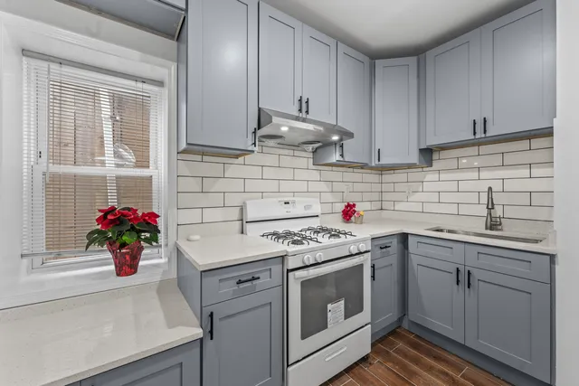 a kitchen with a sink cabinets and appliances
