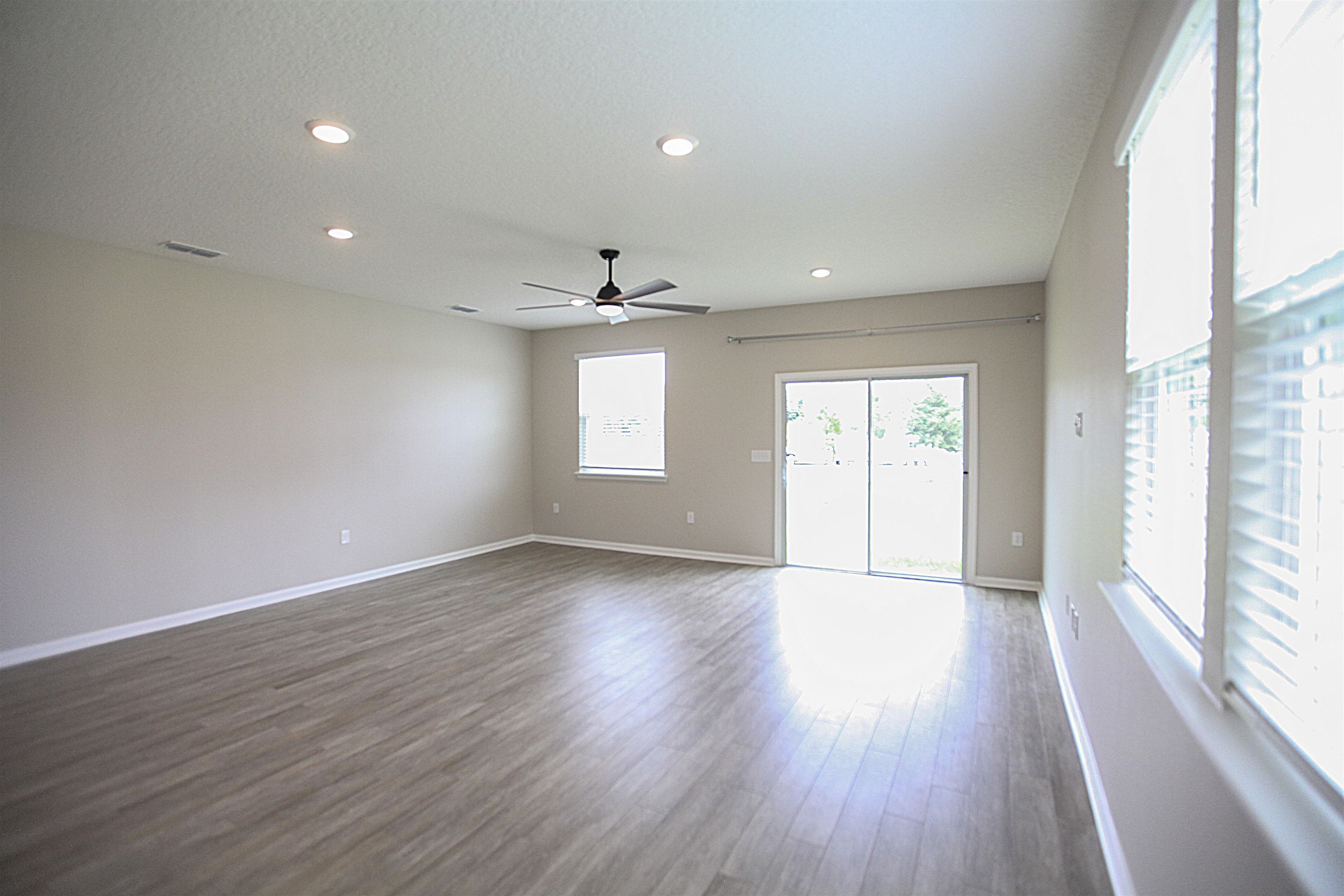 55 Great Star Street St. Augustine, FL 32086 - Photo 12 of 37 a view of an empty room with wooden floor and a window