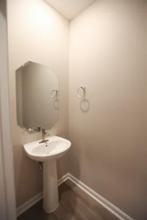 a white toilet sitting next to a white sink