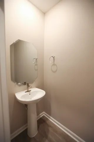 a white toilet sitting next to a white sink