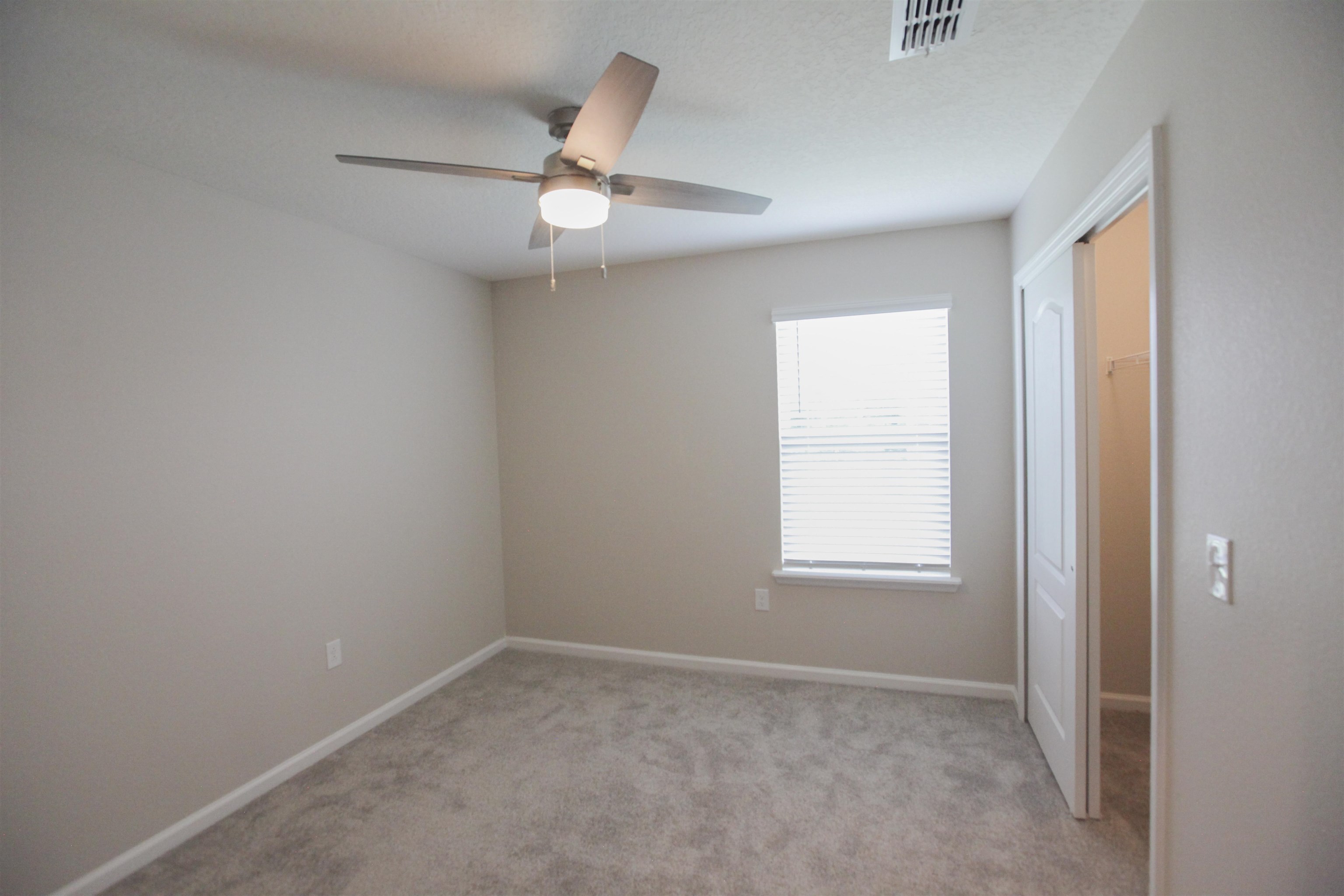55 Great Star Street St. Augustine, FL 32086 - Photo 20 of 37 an empty room with windows and fan