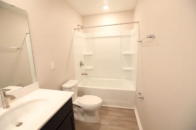 a bathroom with a sink a toilet a mirror and vanity