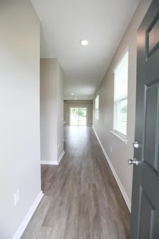 a large kitchen with stainless steel appliances a sink and cabinets