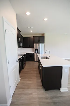 a kitchen with a sink stainless steel appliances and cabinets
