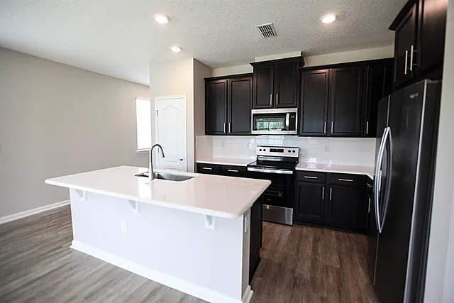 a kitchen with a sink cabinets and window