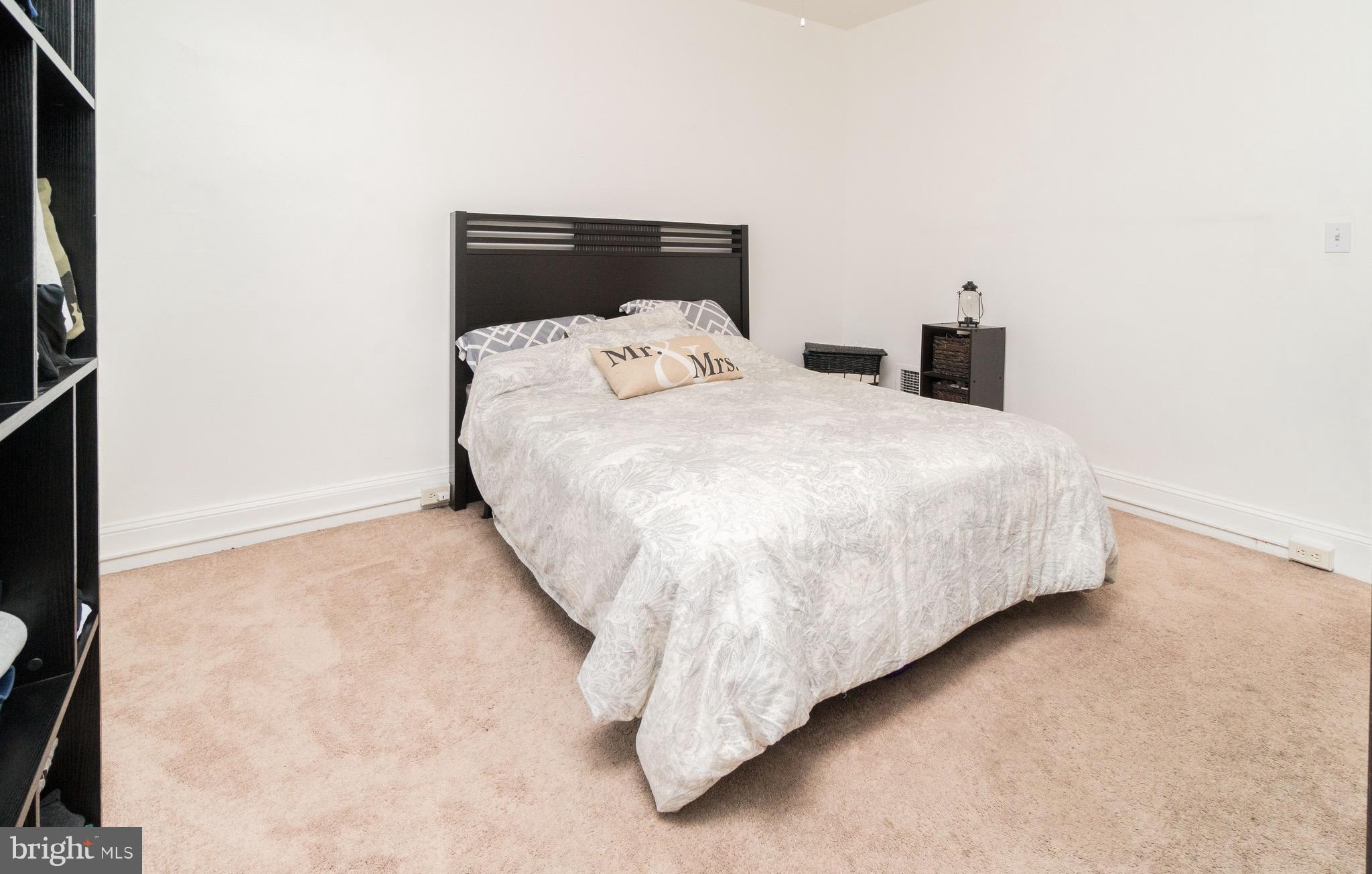626 Rappolla Street Baltimore, MD 21224 - Photo 16 of 24 a large bed sitting in a bedroom next to a window