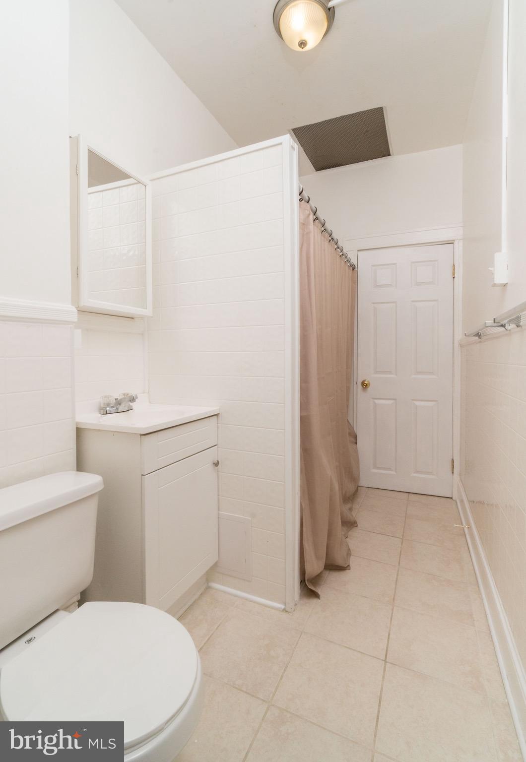626 Rappolla Street Baltimore, MD 21224 - Photo 17 of 24 a white toilet sitting next to a bathroom sink
