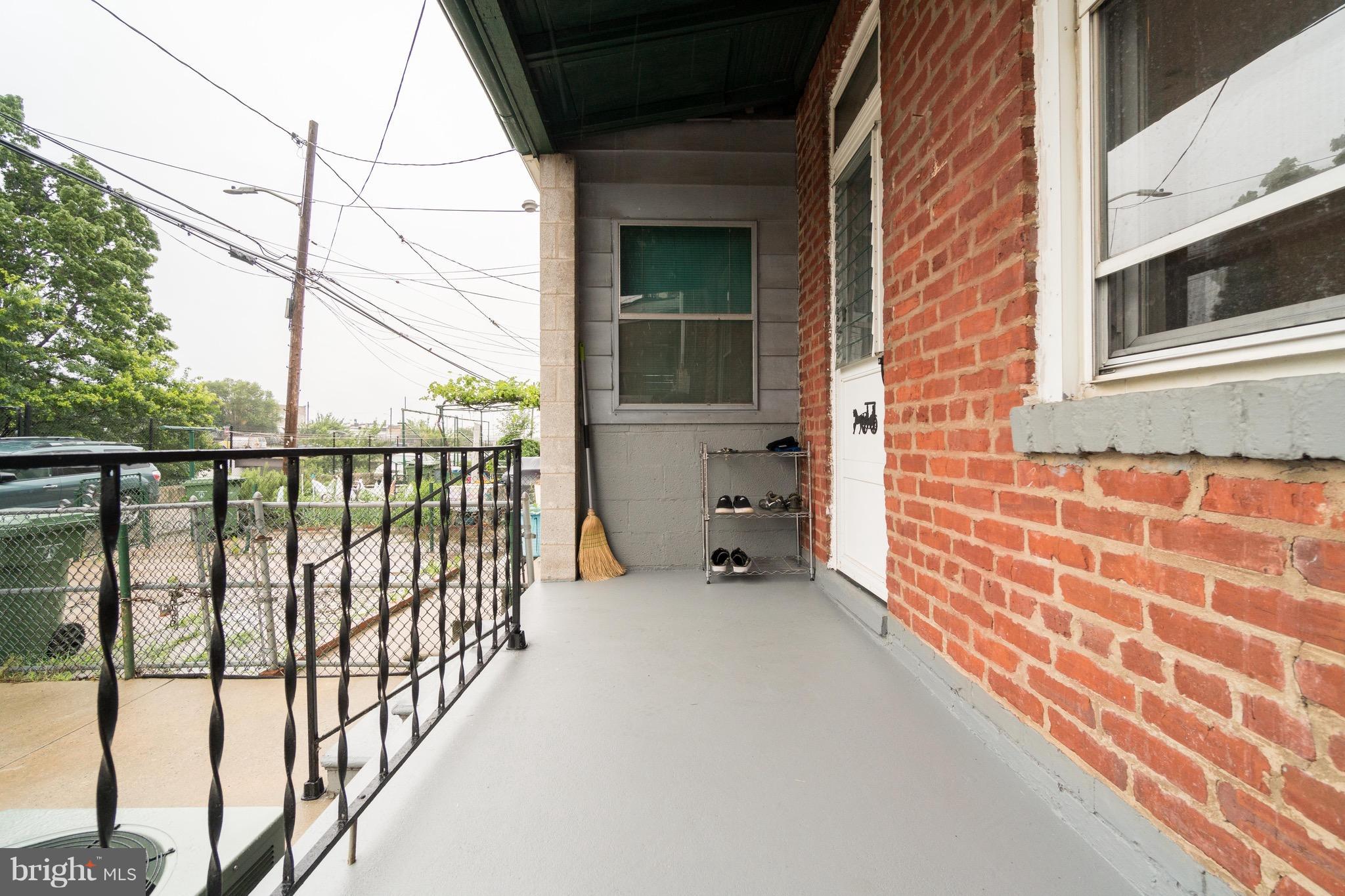 626 Rappolla Street Baltimore, MD 21224 - Photo 22 of 24 a view of a porch with a floor to ceiling window next to a road