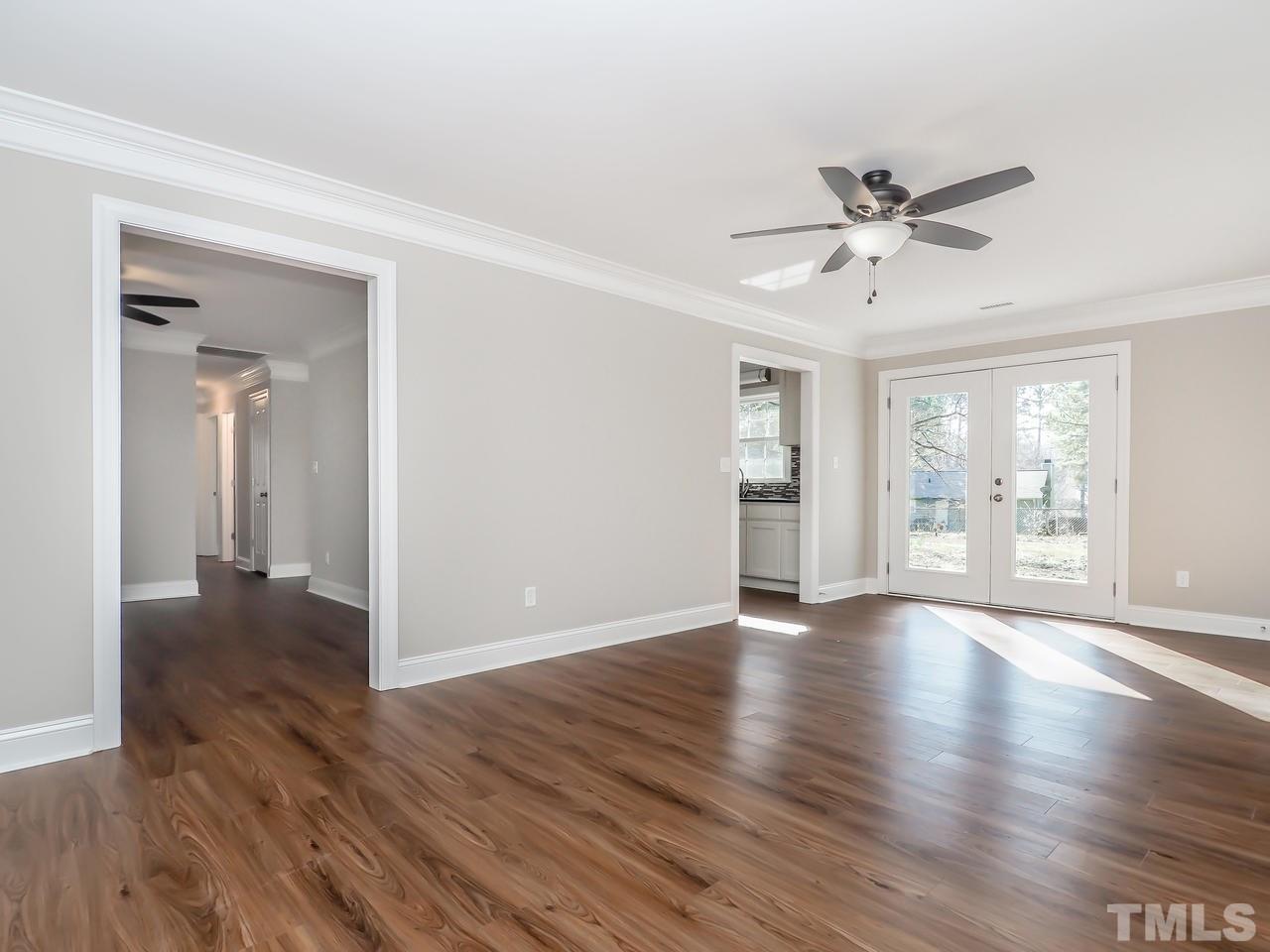1111 Wyldewood Road Durham, NC 27704 - Photo 11 of 17 a view of an empty room with wooden floor and a window