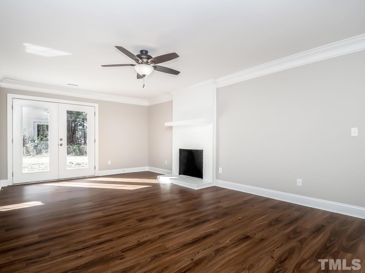 1111 Wyldewood Road Durham, NC 27704 - Photo 13 of 17 a view of an empty room with wooden floor and a window