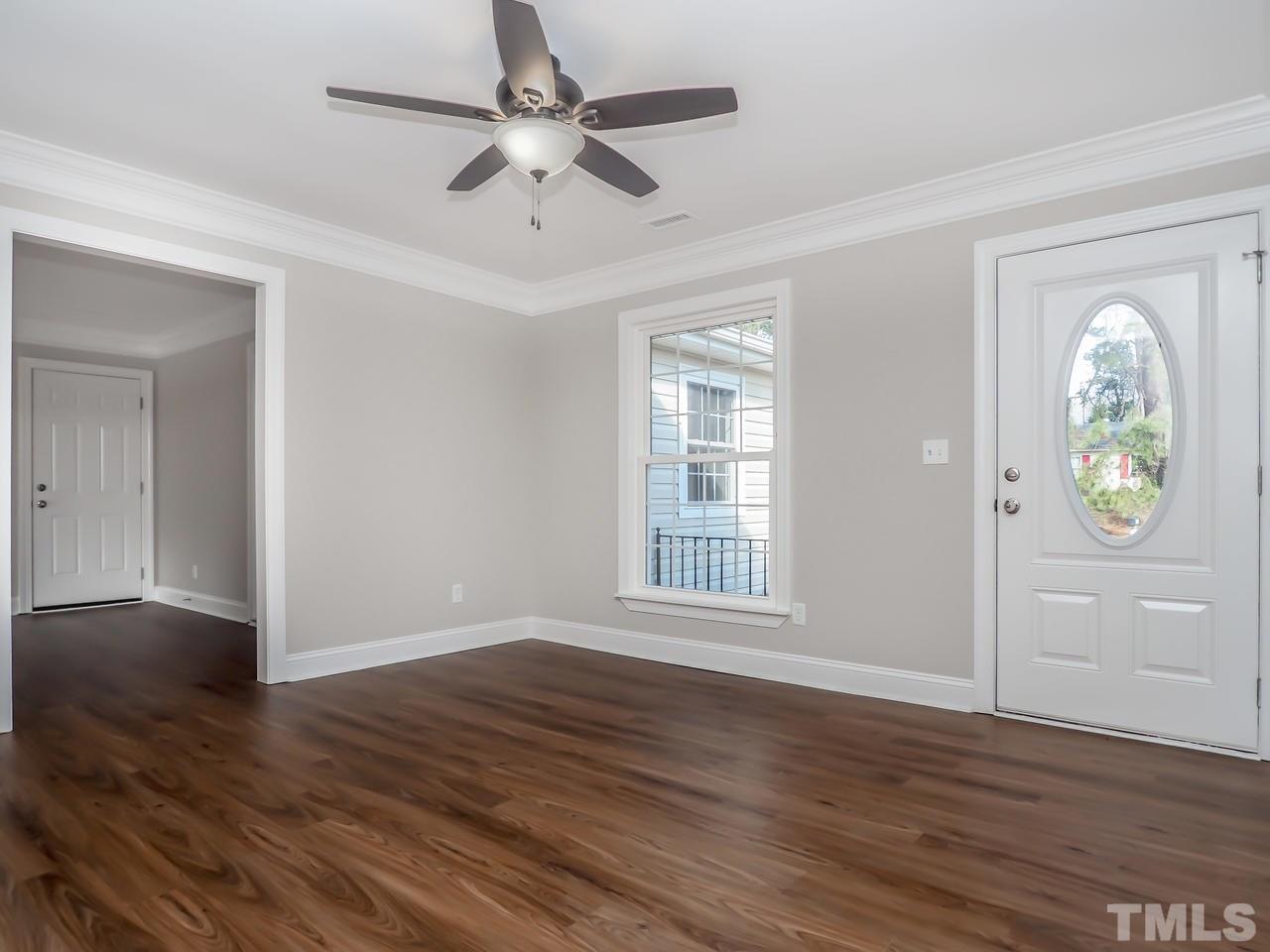 1111 Wyldewood Road Durham, NC 27704 - Photo 15 of 17 a view of an empty room with window and wooden floor