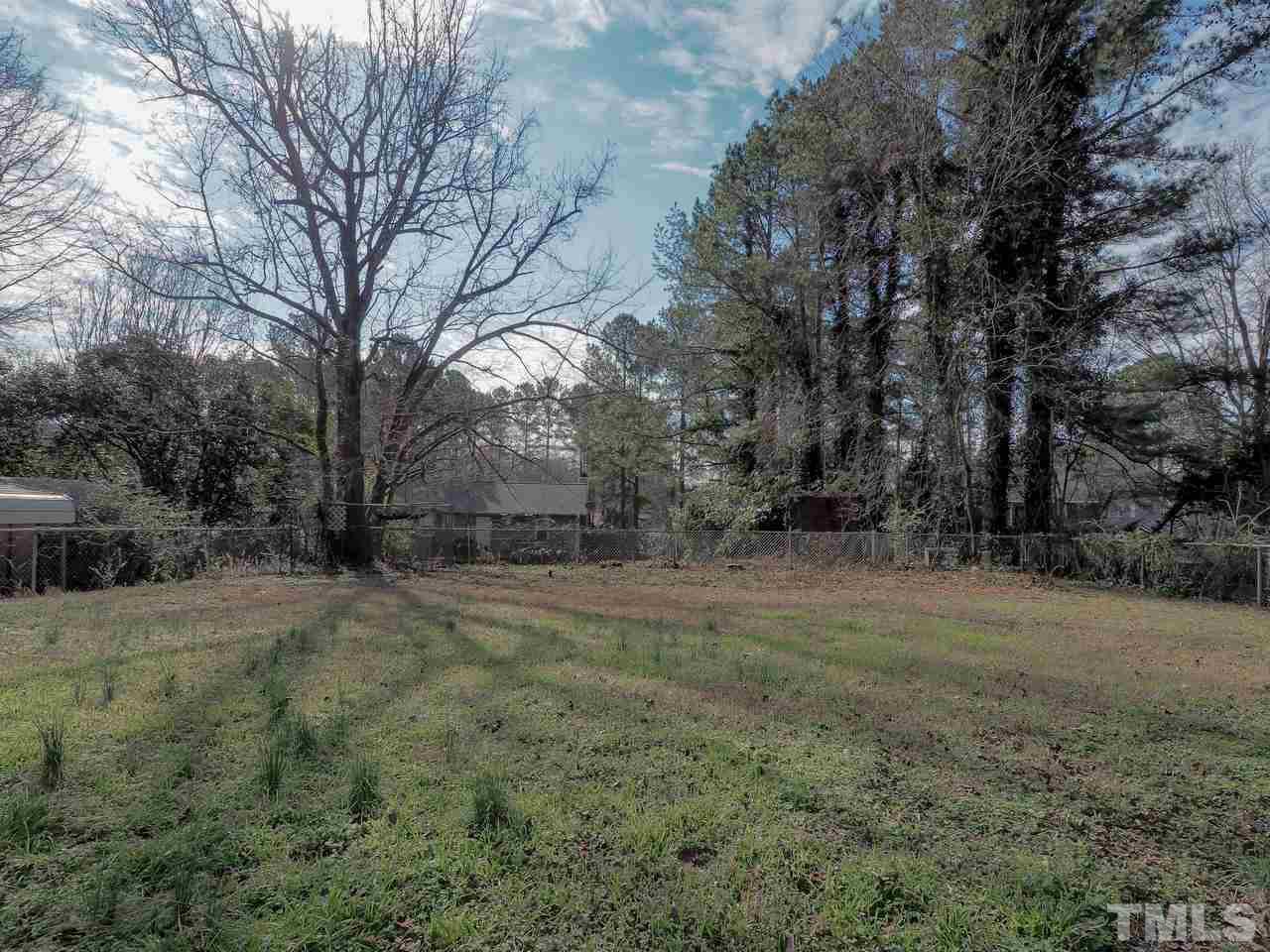 1111 Wyldewood Road Durham, NC 27704 - Photo 17 of 17 a view of a field with large trees
