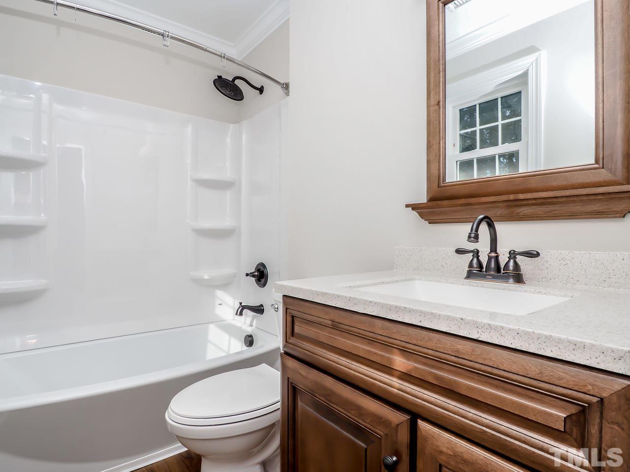 1111 Wyldewood Road Durham, NC 27704 - Photo 4 of 17 a bathroom with a sink a toilet and shower